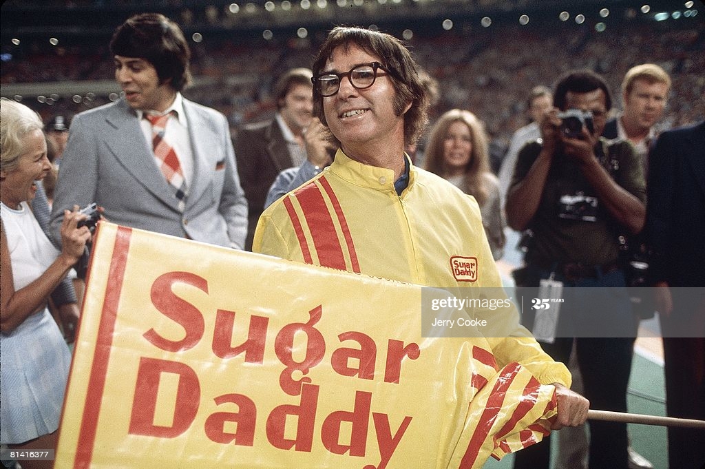 Bobby Riggs preparing to play Billie Jean King in his electric yellow Sugar Daddy sponsored coat.