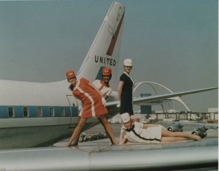 Four female flight attendants pose for a 1970, 40th anniversary United Airlines MOD photoshoot to show off their new A-line dress uniform.